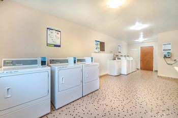 A laundry room with washers and dryers.